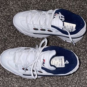 White and navy blue fila sneakers.